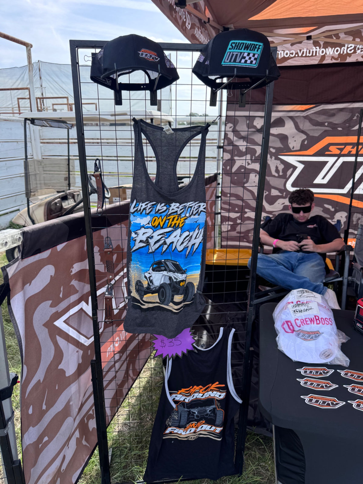 Charcoal Life's Better On The Beach women's racerback tank displayed at the Showoff UTV event booth